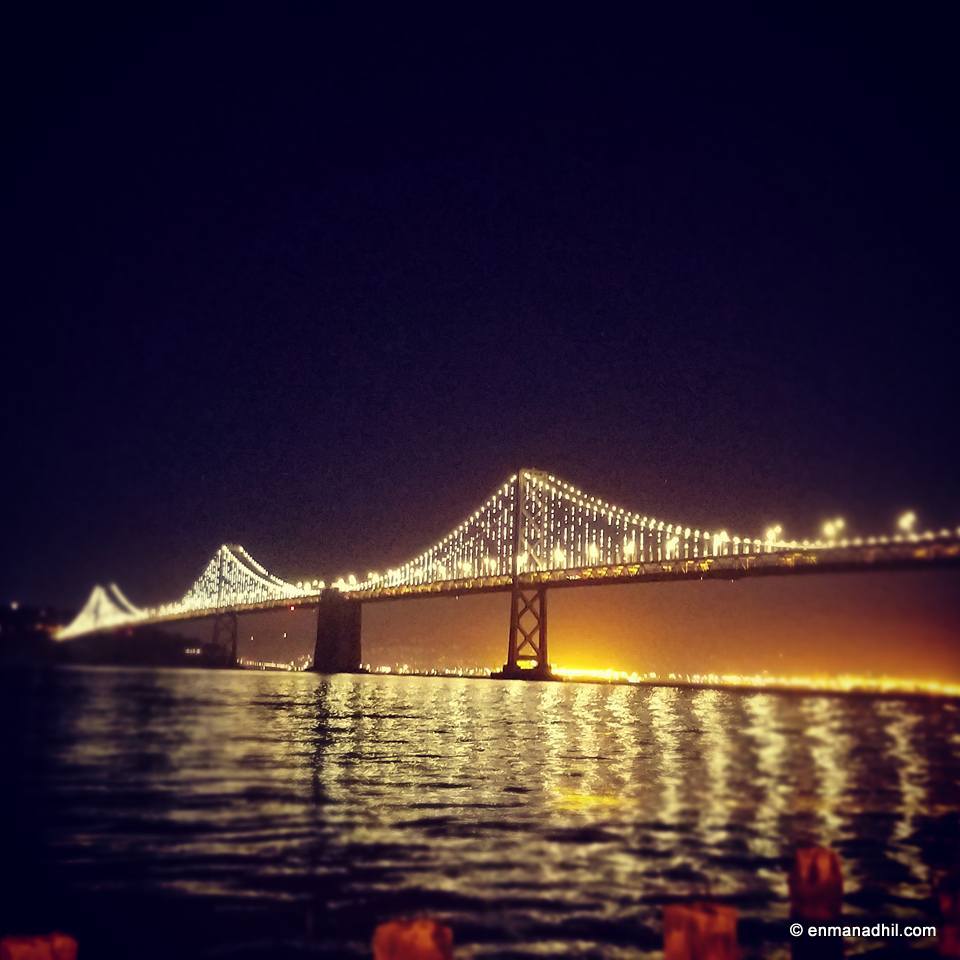 Bay Bridge San Francisco CA lit up in the evening water front
